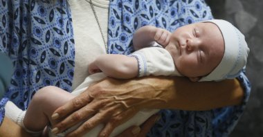 Andreo Diez, from Buenos Aires, Argentina, holds Ignacio, her baby born via a Ukrainian surrogate mother, after spending two weeks in quarantine, due to the coronavirus outbreak, in Kyiv, Ukraine, June 10, 2020. (AP Photo)