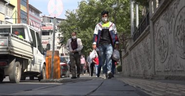 People wearing protective masks against COVID-19 walk on a street in Bingöl, eastern Turkey, Oct. 21, 2020. (İHA Photo) 