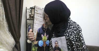 Rana kisses a photo of her son, Eyad Hallaq, in their home in Wadi Joz, a Palestinian neighborhood in east Jerusalem, June 3, 2020. (AP Photo)