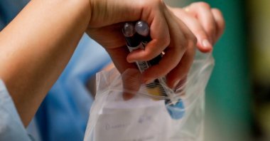 A nurse packs samples after drawing blood from a coronavirus patient in the COVID-19 hospitalization unit at the Etterbeek-Ixelles site of the Iris Sud Hospitals in Brussels, Belgium, Oct. 21, 2020. (EPA Photo)