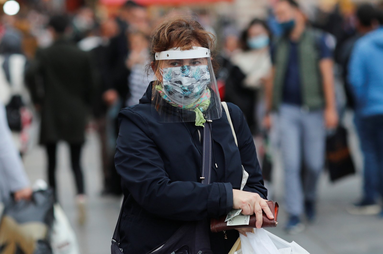 A woman wearing a protective mask and a face shield shops at a market amid the outbreak of COVID-19, in Istanbul, Turkey, Oct. 20, 2020. REUTERS/Murad Sezer
