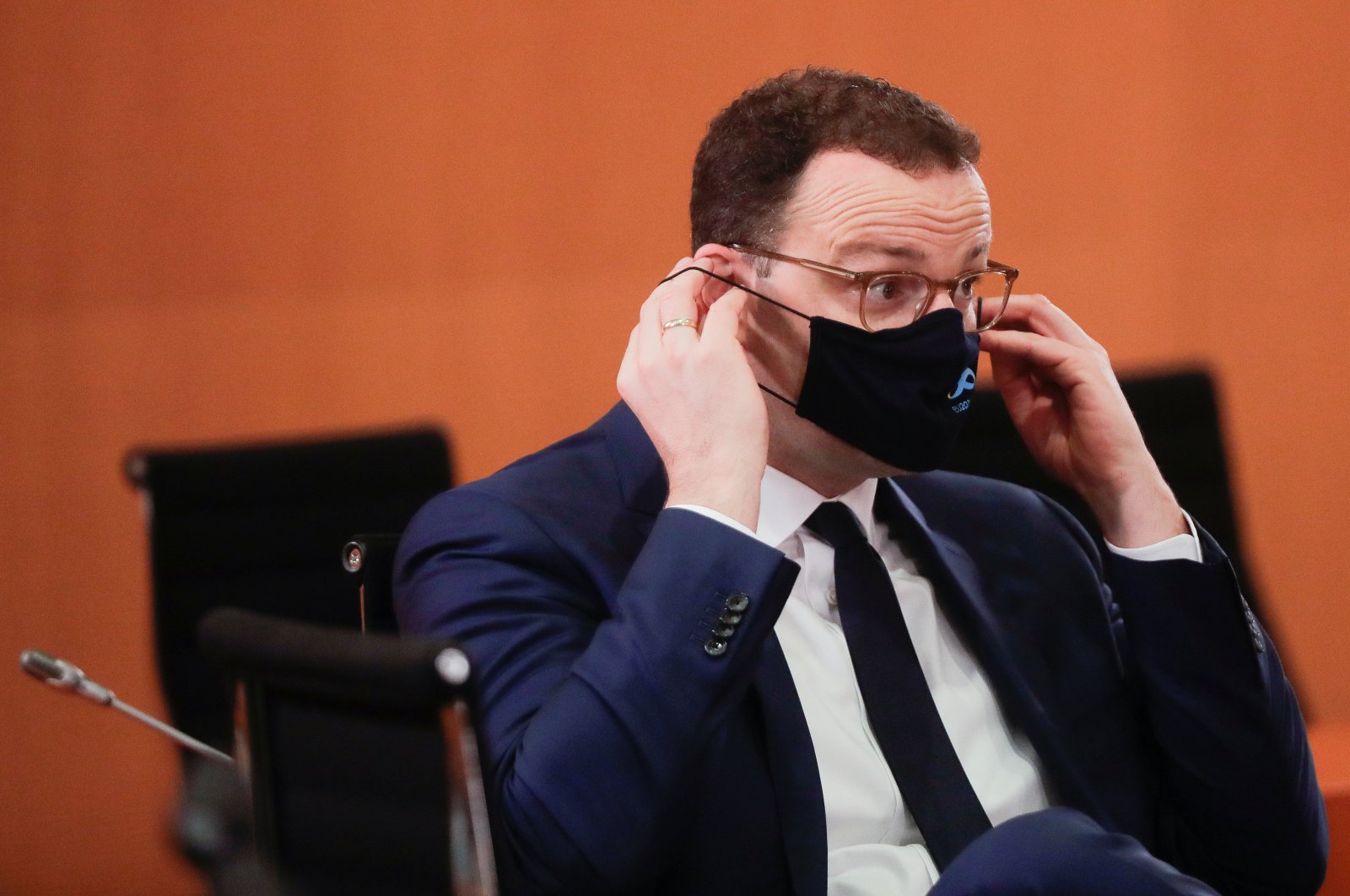 German Health Minister Jens Spahn adjusts his mask as he attends the weekly Cabinet meeting of the government at the German Chancellery, Berlin, Oct. 21, 2020. (REUTERS Photo)