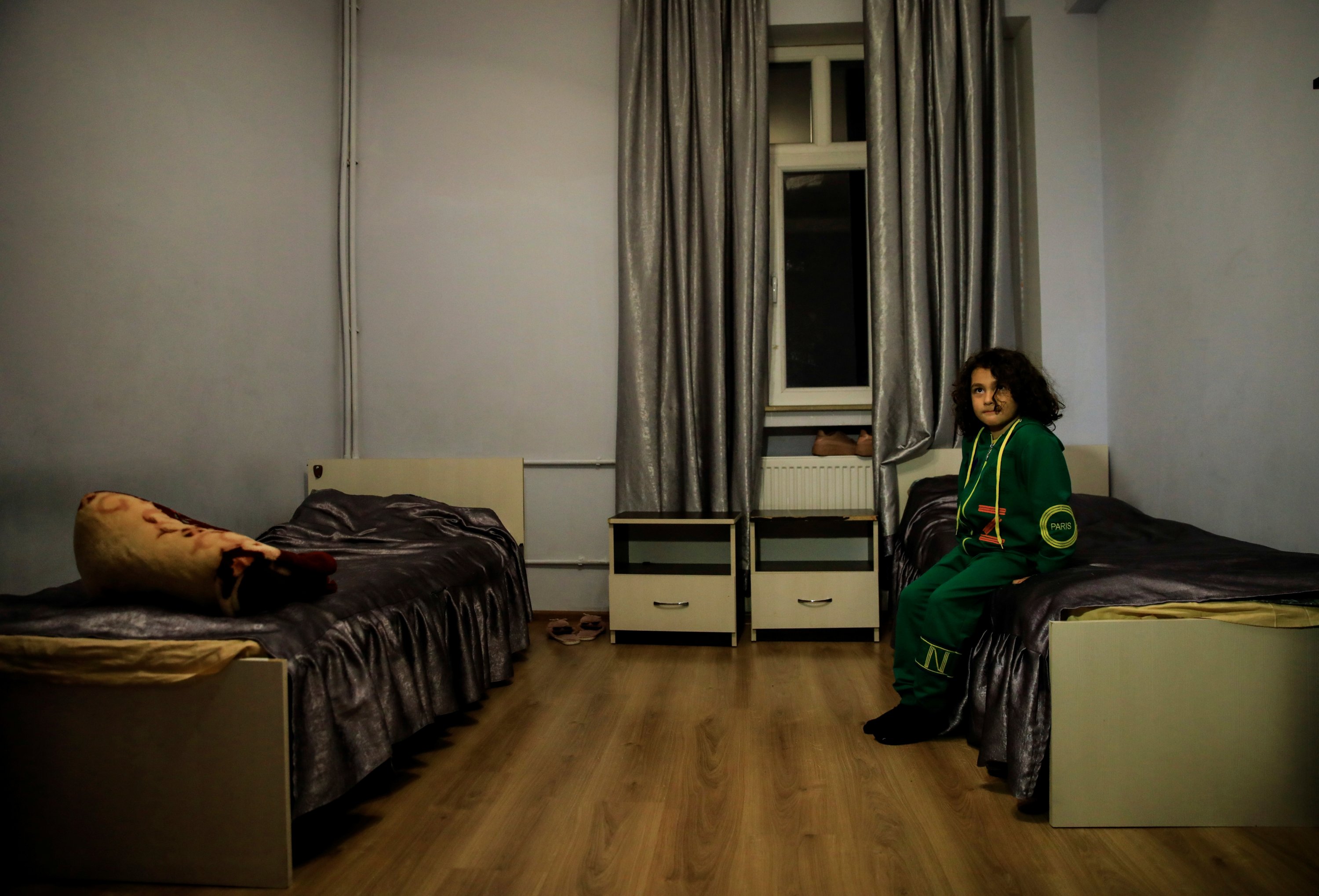 Sahil Memedzade, 6, sits in a dormitory room where he is settled with his family after his home was ruined by an Armenian rocket during the fighting over the occupied region of Nagorno-Karabakh in the city of Ganja, Azerbaijan, Oct. 21, 2020. REUTERS