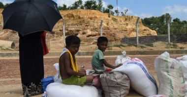 Rohingya refugee children sit on relief supplies at Kutupalong refugee camp, Ukhia, Bangladesh, Oct. 15, 2020. (AFP Photo)