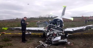 A police officer checks the wreckage of the plane, in Istanbul, Turkey, Oct. 22, 2020. (AA Photo)