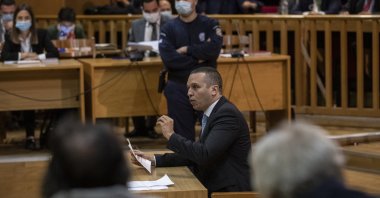 Iias Kasidiaris, former Golden Dawn lawmaker who had been found guilty along with others of leading a criminal organization and face 13 years in prison, speaks during a Golden Dawn trial, in Athens, Oct. 21, 2020. (AP Photo)