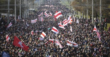 People with old Belarusian national flags march during an opposition rally to protest the official presidential election results in Minsk, Belarus, Oct. 18, 2020. (AP Photo)