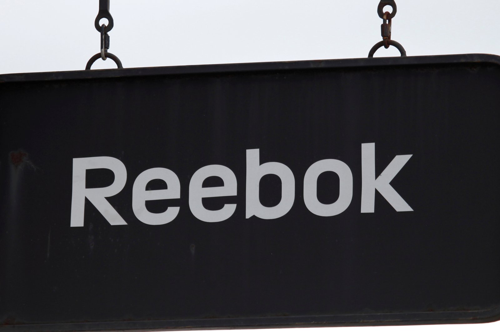 A board with a Reebok store logo is seen in a shopping center at the outlet village Belaya Dacha outside Moscow, Russia, April 23, 2016.  (Reuters Photo)