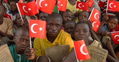 Students hold Turkish flags in a dormitory restored by donations provided by Turkish charities and businesspeople, in the capital Abuja, Nigeria, Oct. 4, 2019. (AA Photo)