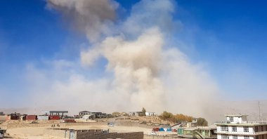 Smoke rises from the site of a car bomb attack that targeted Afghan police headquarters in Feroz Kho, the capital of Ghor Province on Oct. 18, 2020. (AFP Photo)