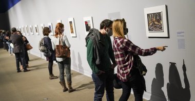 Visitors wearing masks observe COVID-19 prevention protocols as they browse the "Jacob Lawrence: The American Struggle" exhibition at the Metropolitan Museum of Art, in New York, Oct. 17, 2020. (AP Photo)