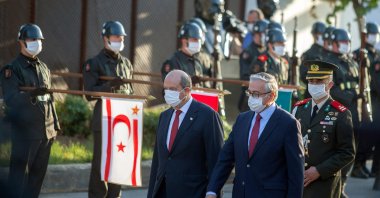 Former Turkish-Cypriot leader Mustafa Akıncı (R) and newly elected President Ersin Tatar, arrive at a handover ceremony in the northern part of Nicosia, the capital of the Turkish Republic of Northern Cyprus (TRNC), Oct. 23, 2020. (AFP Photo)