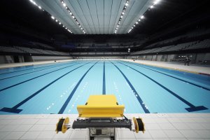 A starting block of the swimming pool at an empty Tokyo Aquatics Center following the Tokyo 2020 organizing committee's grand opening ceremony Saturday at the facility where the city plans to host Olympic artistic swimming, diving and swimming and Paralympics swimming events in 2021, Tokyo, Oct. 24, 2020. (AP Photo/Eugene Hoshiko)