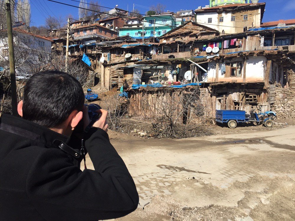 A photographer takes photos of the old houses in Demirci, Manisa, western Turkey, Oct. 22, 2020. (AA PHOTO)