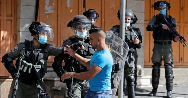 A Palestinian youth scuffles with an Israeli border police officer in the Israeli-occupied West Bank, Oct. 23, 2020. (REUTERS Photo)