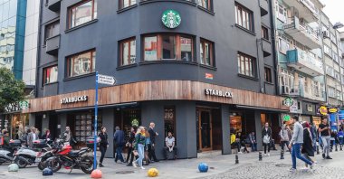 People are seen in front of a Starbucks coffee shop on the tourist street Bahariye in Kadiköy district on the Asian side of Istanbul, Oct. 4, 2018. (Shutterstock Photo)