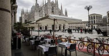 Empty tables of a restaurant in the Duomo Square in Milan, Italy, Oct. 21, 2020. (AP Photo)