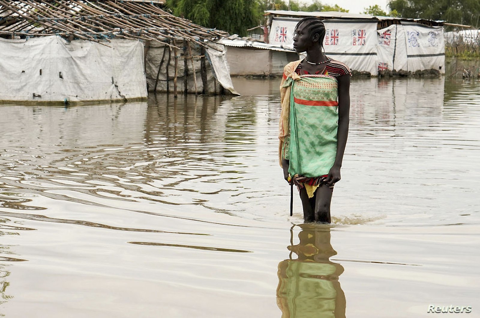 A girl walks in water after heavy rains and floods forced hundreds of thousands of people to leave their homes, in the town of Pibor, Boma state, South Sudan, Nov. 6, 2019. (REUTERS Photo)