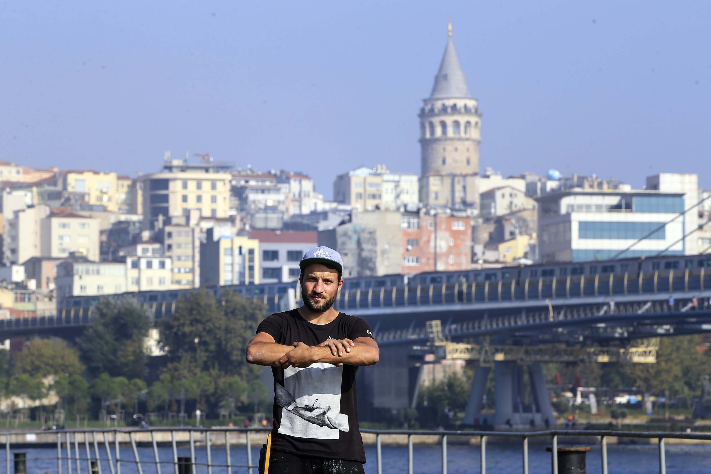 French artist Saype poses near the Atatürk Bridge on the Golden Horn in Istanbul on Oct. 26, 2020. (AA PHOTO)