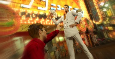 A screengrab from the game shows Kiryu Kazuma with a wad of cash in Yakuza 0. (Credit: Sega Games)