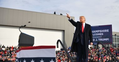 U.S. President Donald Trump waves as he departs, after speaking during a campaign rally at Manchester-Boston Regional Airport in Londonderry, New Hampshire, Oct. 25, 2020. (AFP Photo)