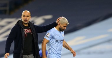 Manchester City coach Pep Guardiola (L) consoles Sergio Aguero after being substituted during a Premier League match against Arsenal, in Manchester, England, Oct. 17, 2020. (AP Photo)