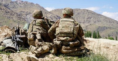 In this file photo, U.S. soldiers look out over hillsides during a visit of the commander of U.S. and NATO forces in Afghanistan Gen. Scott Miller at the Afghan National Army (ANA) checkpoint in Nerkh district of Wardak province, June 6, 2019. (AFP Photo)