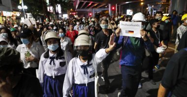 Pro-democracy protesters flash three fingers as they march to the German Embassy in central Bangkok, Thailand, Oct. 26, 2020. (AP Photo)