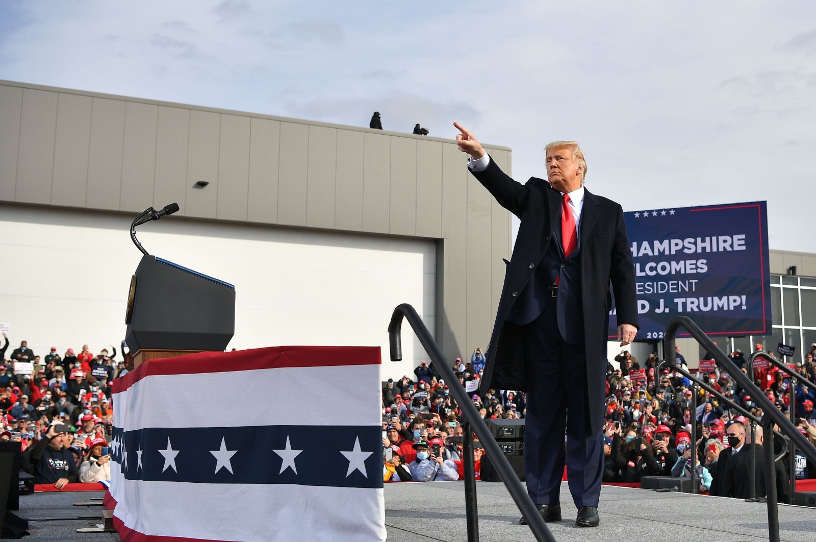 U.S. President Donald Trump waves as he departs, after speaking during a campaign rally at Manchester-Boston Regional Airport in Londonderry, New Hampshire, Oct. 25, 2020. (AFP Photo)