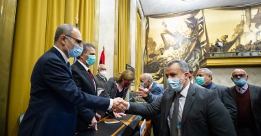 Representatives of Libya's two rival factions shake hands after a signing ceremony, on Oct. 23, 2020. (AFP Photo)
