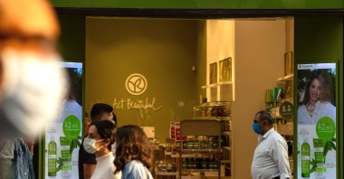 Tourists wait in front of the French brand shop "Yves Rocher" in Istanbul, Oct. 26, 2020. (AFP Photo)