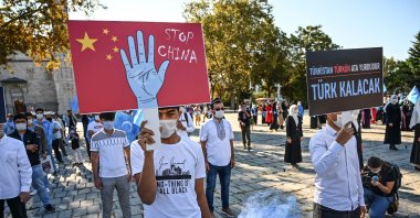 A man holds a placard reading "Stop China" during a demonstration against China's treatment of Muslim minorities in Xinjiang region, at Beyazid Square in Istanbul, Oct. 1, 2020. (AFP Photo)