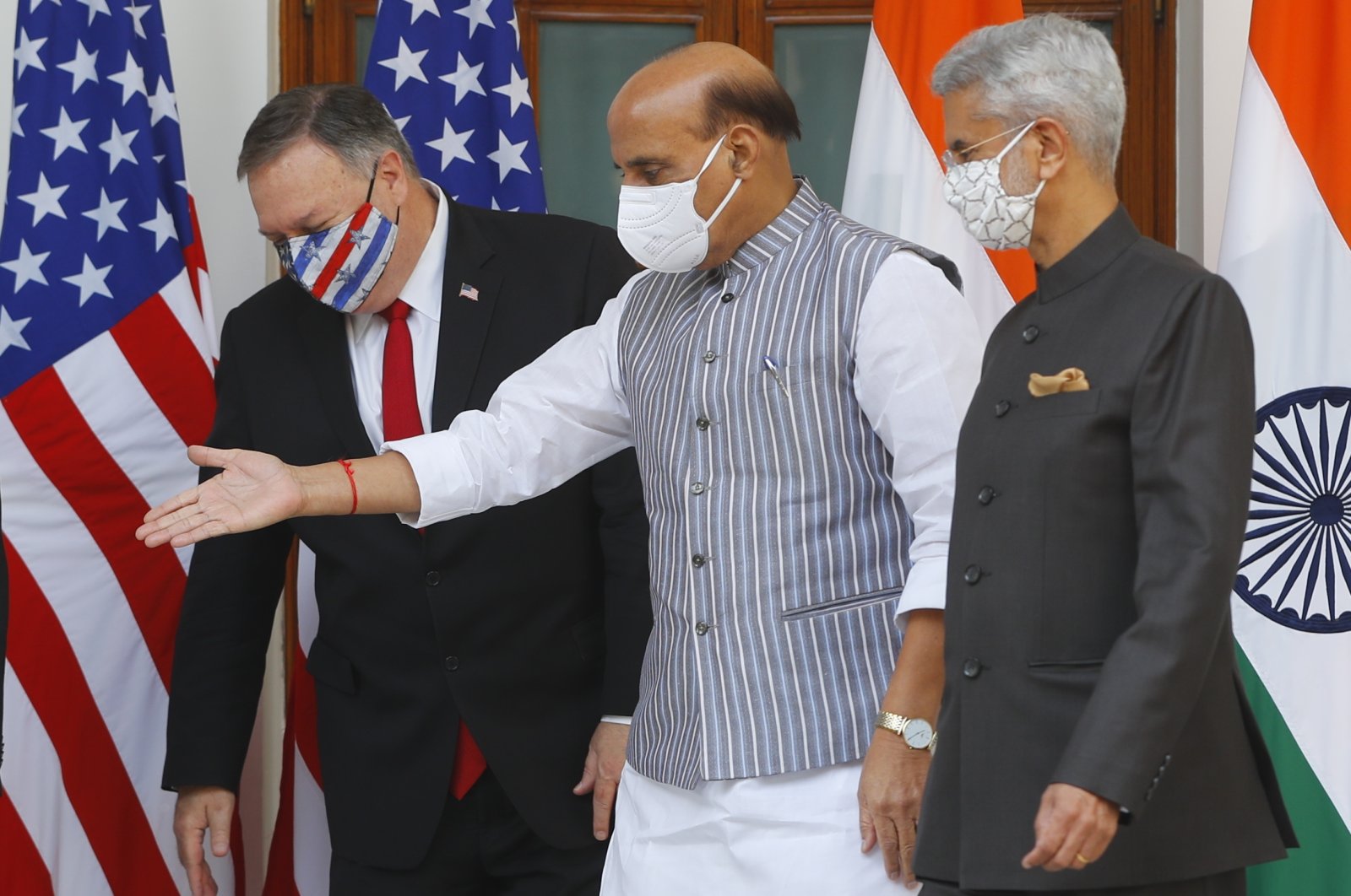Indian Defence Minister Rajnath Singh (C), gestures towards U.S. Secretary of State Mike Pompeo (L), with Indian Foreign Minister Subrahmanyam Jaishankar, standing beside him, ahead of their meeting at Hyderabad House in New Delhi, India, Tuesday, Oct. 27, 2020. (AP Photo)