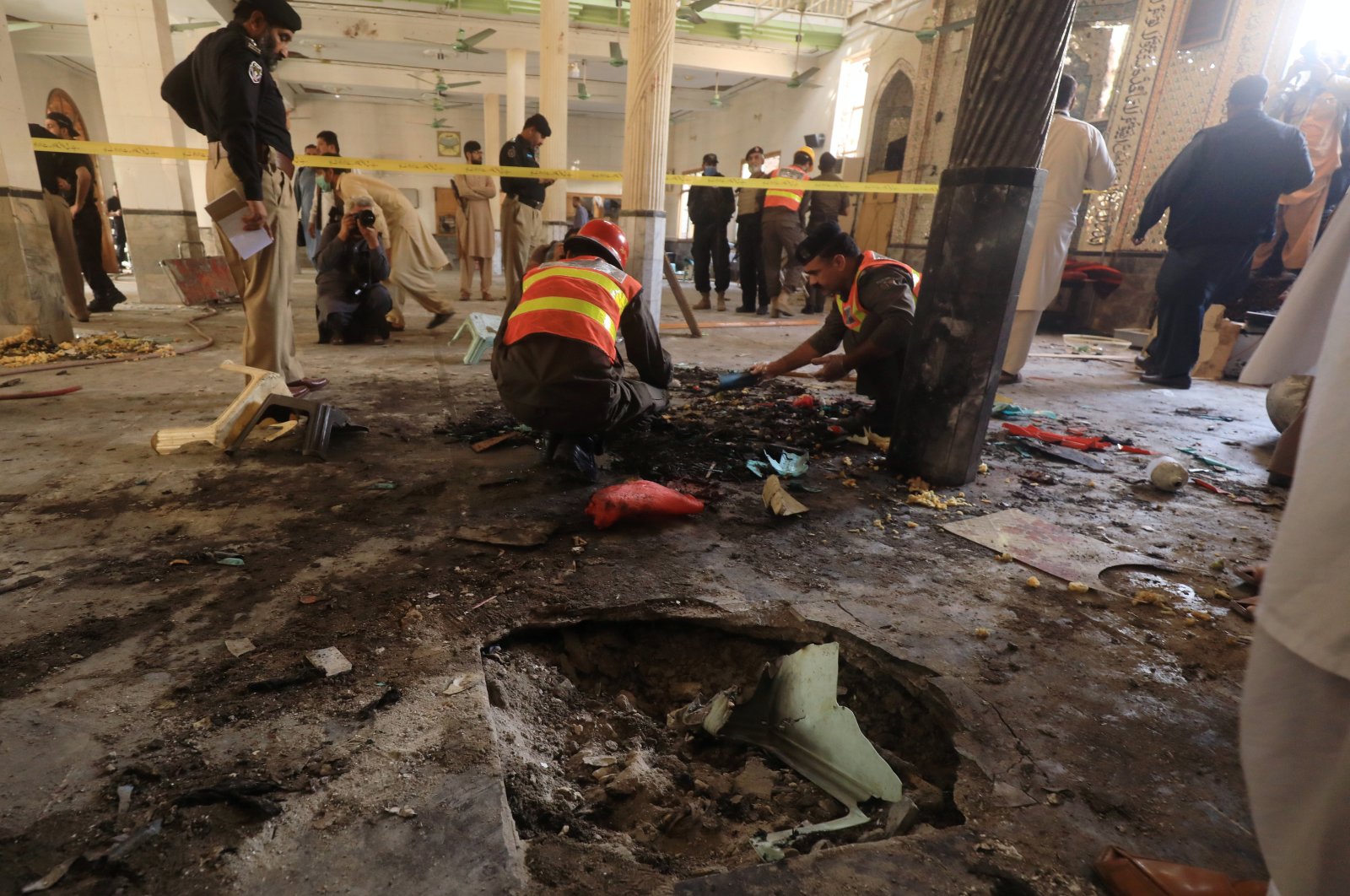 Rescue workers search for body parts at the site of a bomb blast at a religious seminary in Peshawar, Pakistan, Oct. 27, 2020. (Reuters Photo)