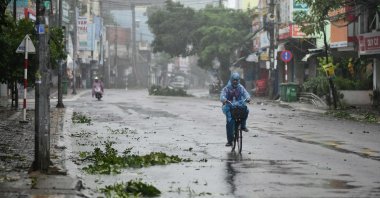 A man rides along a deserted road amid strong winds in central Vietnam's Quang Ngai province as Typhoon Molave makes landfall, on Oct. 28, 2020. (AFP Photo)