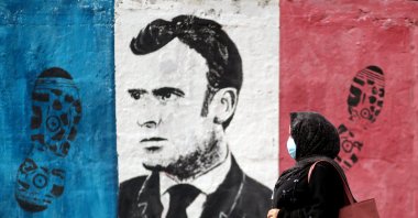 A Palestinian woman walks past an anti-French President Emmanuel Macron mural painted by an artist to protest against the publication of a cartoon of the Prophet Muhammad in France and Macron's comments, in Gaza City, Oct. 28, 2020. (Reuters Photo)