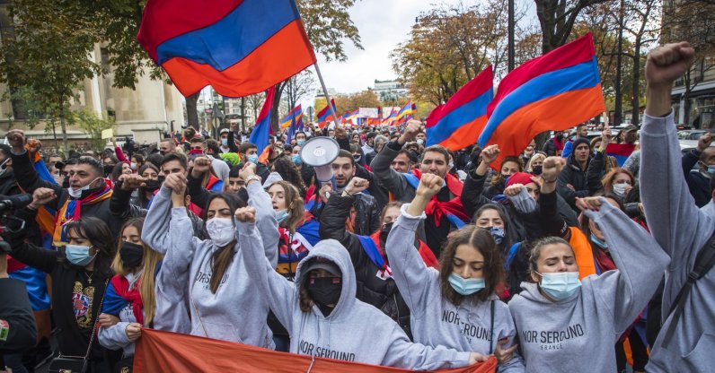 French-Armenian protesters hold Armenian flags as they shout slogans against Turkey during a demonstration supporting Armenia in Nagorno-Karabakh conflict in Paris, France, 25 October 2020. (EPA Photo)
