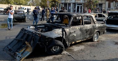 Journalists work at the site hit by recent shelling during the ongoing military conflict between Armenia and Azerbaijan over the Nagorno-Karabakh region in the town of Barda, Azerbaijan, Oct. 28, 2020. (AFP Photo)