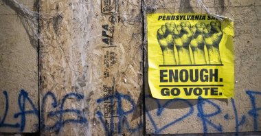 A sign that reads "ENOUGH GO VOTE" and graffiti that reads "WALTER WALLACE RIP" are seen, Philadelphia, Pennsylvania, Oct. 28, 2020. (AFP Photo)