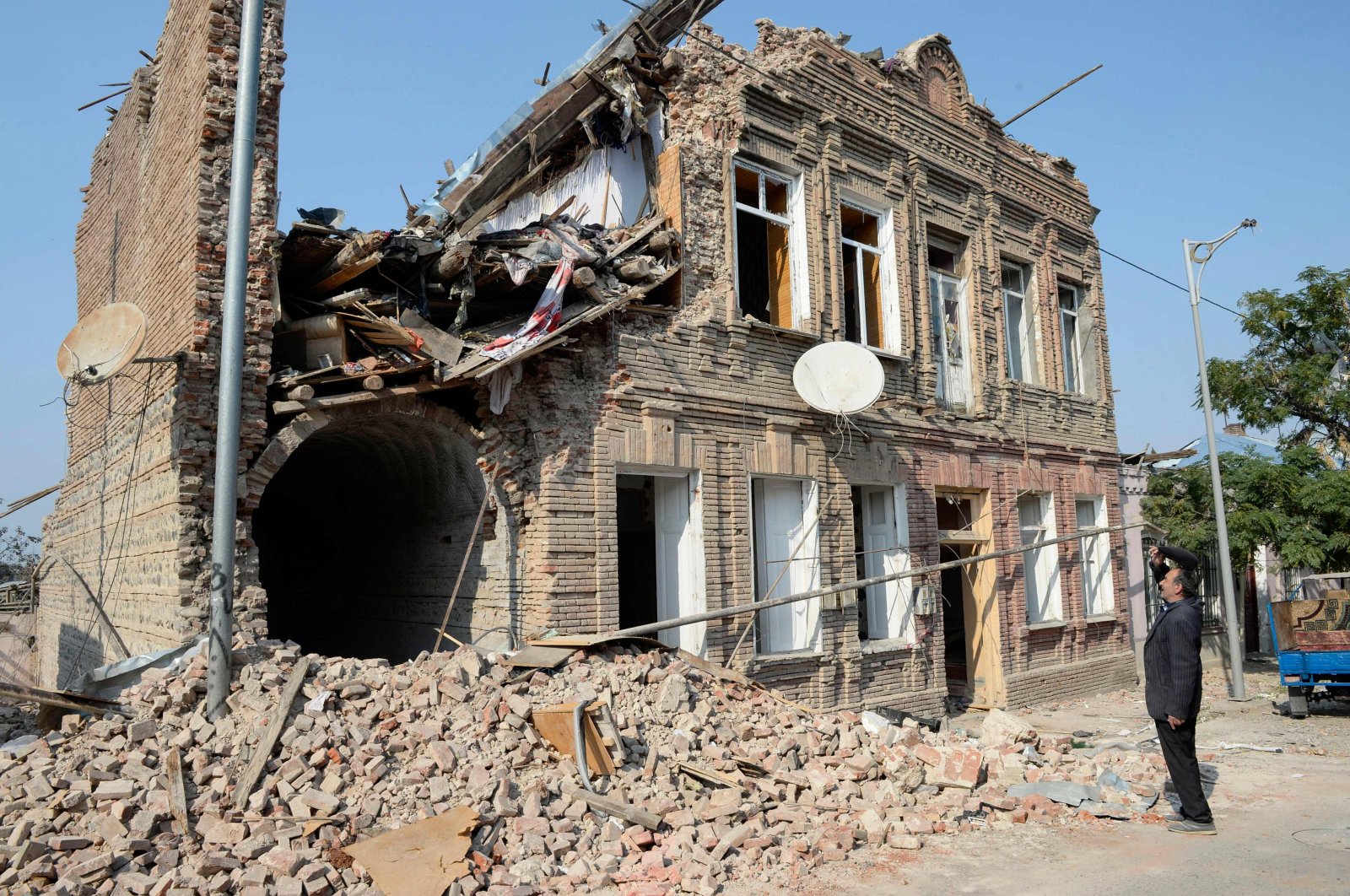 A man looks at a residential building damaged by Armenian shelling, in Ganja, Azerbaijan, Oct. 27, 2020. (AFP Photo)