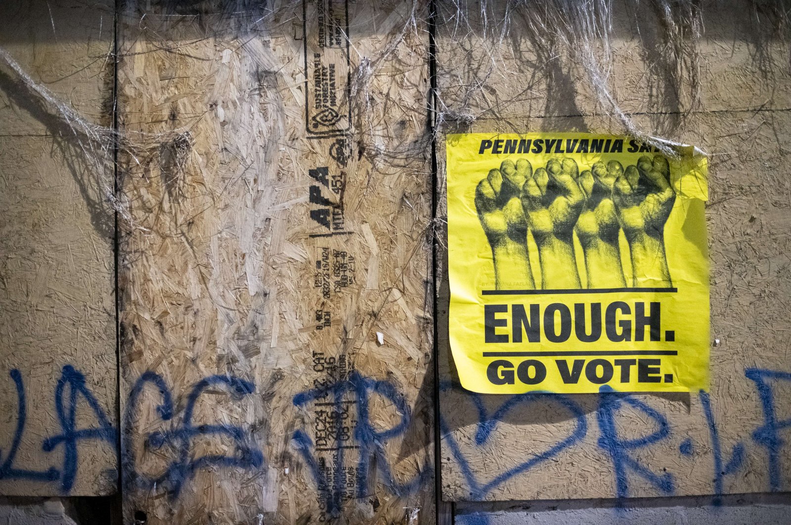 A sign that reads "ENOUGH GO VOTE" and graffiti that reads "WALTER WALLACE RIP" are seen, Philadelphia, Pennsylvania, Oct. 28, 2020. (AFP Photo)