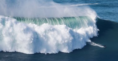 A surfer rides a wave amid a giant swell at Praia do Norte in Nazare, Portugal, Oct. 29, 2020. (AFP Photo)