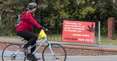 In this Oct. 15, 2020, file photo, a cyclist rides past a sign in support of making marijuana legal in Christchurch, New Zealand. (AP Photo)
