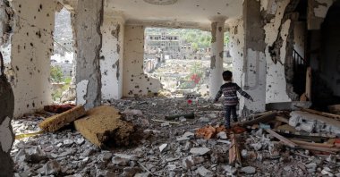 A child walks amidst the rubble of a building that was destroyed in Saudi-led coalition's airstrike in Taez, Yemen, March 18, 2018. (AFP Photo)