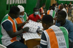 Electoral commission officials check the voter's roll as they count votes for Ivory Coast's presidential election at a polling station in Abidjan, Ivory Coast, Oct. 31, 2020. (AFP Photo)