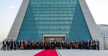 Members of the Presidential Symphony Orchestra stand in front of the new CSO building, Ankara, Turkey.