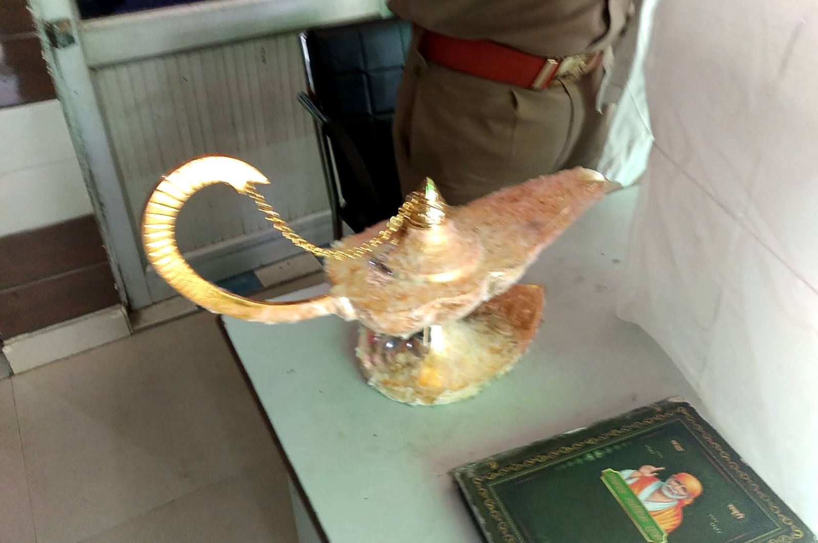 The lamp that was allegedly sold for $93,000 with the claim that it had magical powers, as described in the popular folk tale "Aladdin," at the Brahampuri police station in New Delhi, Oct. 29, 2020. (Uttar Pradesh Police Photo via AFP)