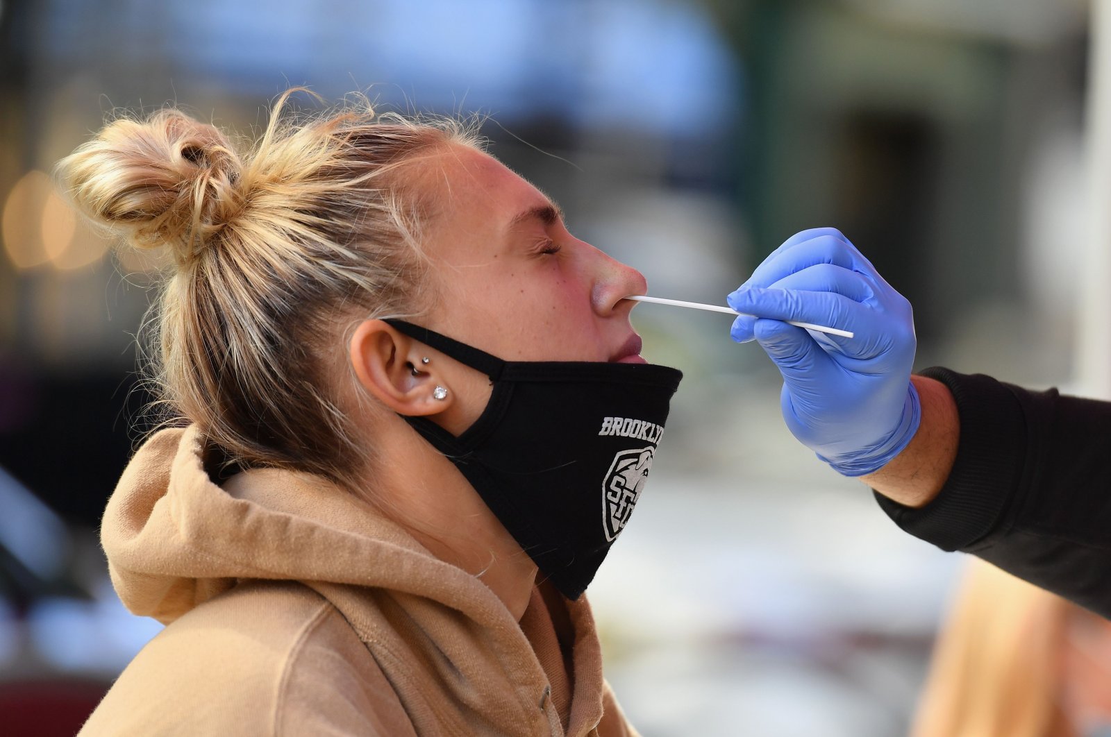 A medical worker takes a nasal swab sample from a student to test for COVID-19 at the Brooklyn Health Medical Alliance urgent care pop-up testing site as infection rates spike in New York City, U.S., Oct. 8, 2020. (AFP Photo)