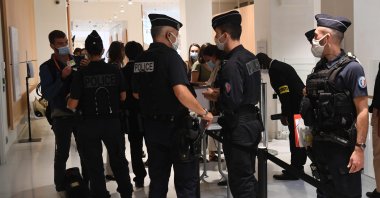 Police officers control people arriving at Paris' courthouse for the opening of the Charlie Hebdo trial, Sept. 2, 2020. (AFP Photo)