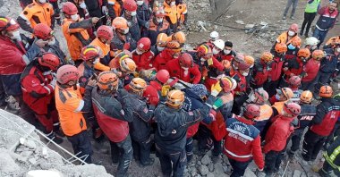Rescue workers carry 3-year-old Elif Perinçek from the rubble, in Izmir, western Turkey, Nov. 2, 2020. (AA Photo) 
